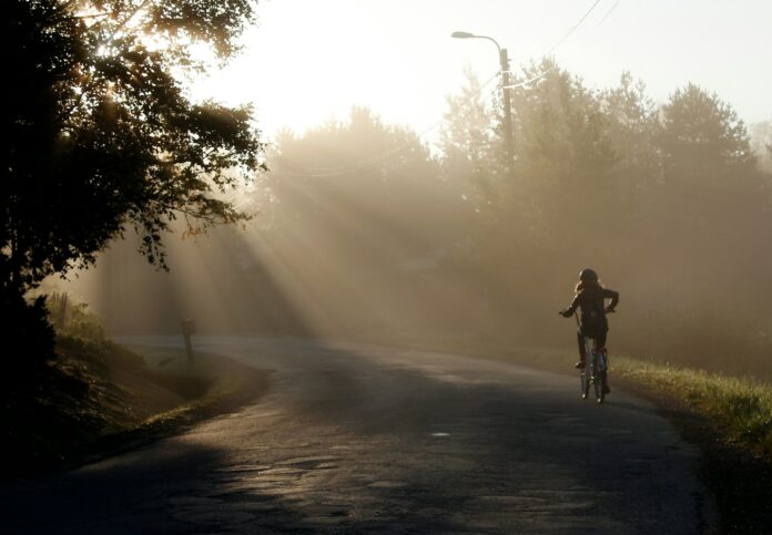 a person riding a bike down a road