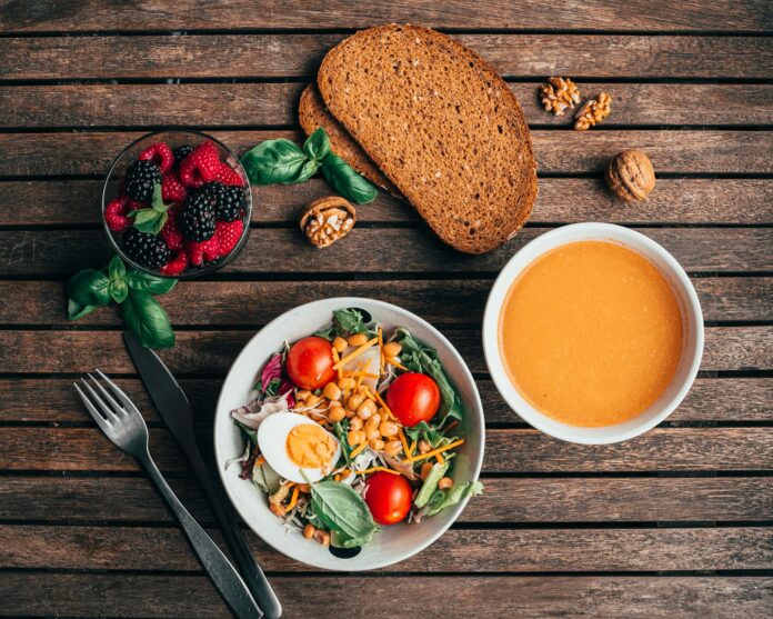 Photo by Khaled Ali sliced bread with sliced tomato and green vegetable on white ceramic plate
