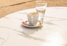 “소소하지만 확실한 변화, 스트레스 관리의 새로운 루틴” Smartphone and coffee cup on marble table