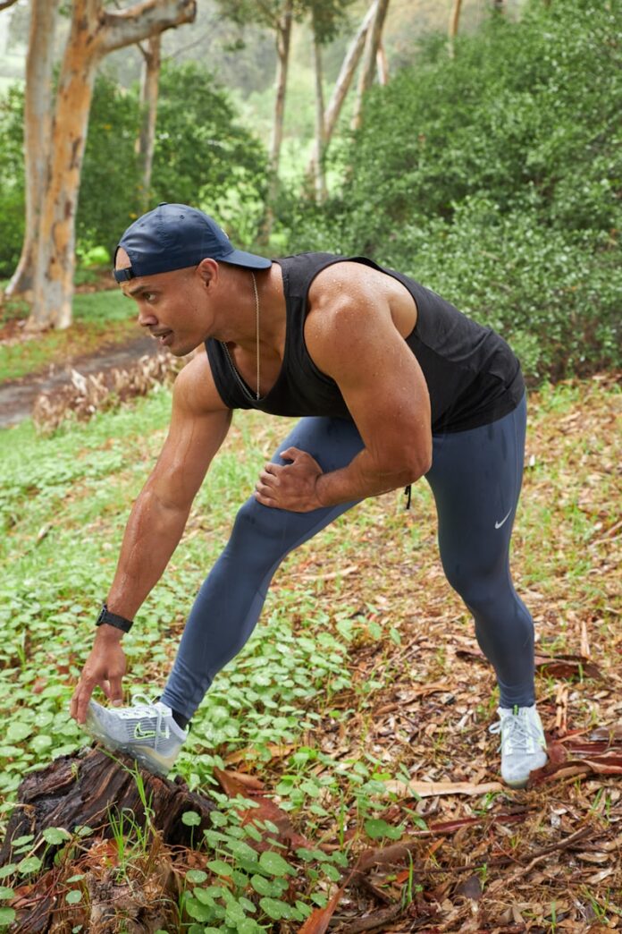 Photo by Sweet Life a man in a black tank top and blue leggings
